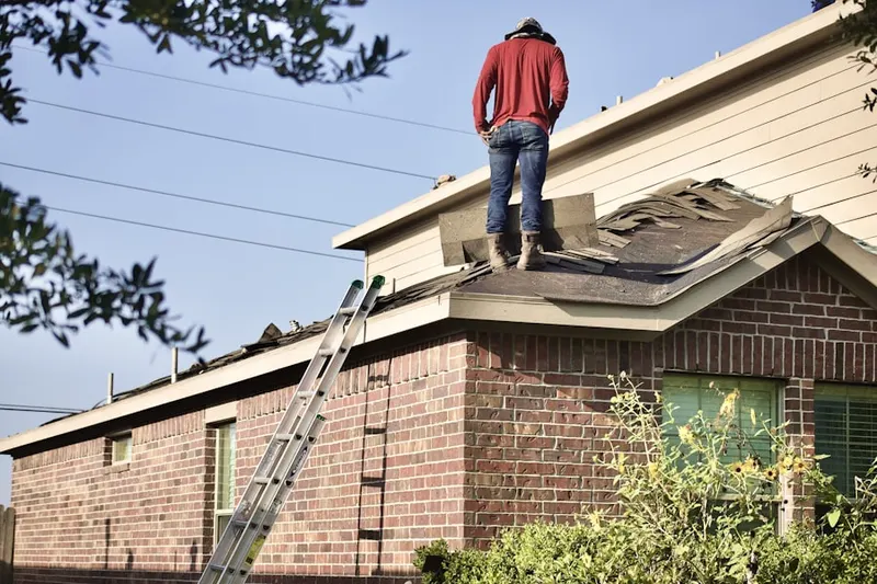 Professional roofer working on a residential roof in Crum Lynne